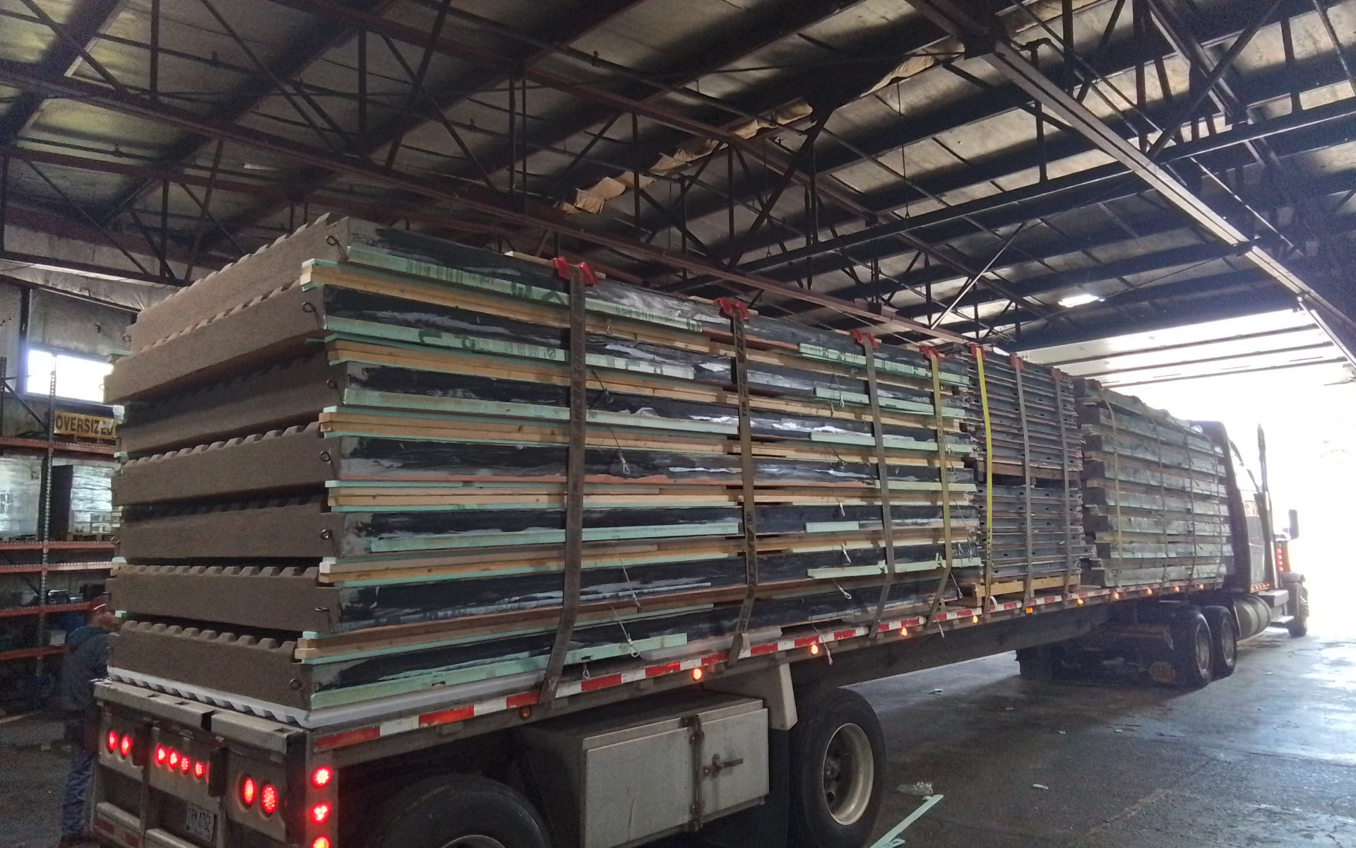 Truckload of Infinity Wall System panels staged for shipment inside the fabrication facility
