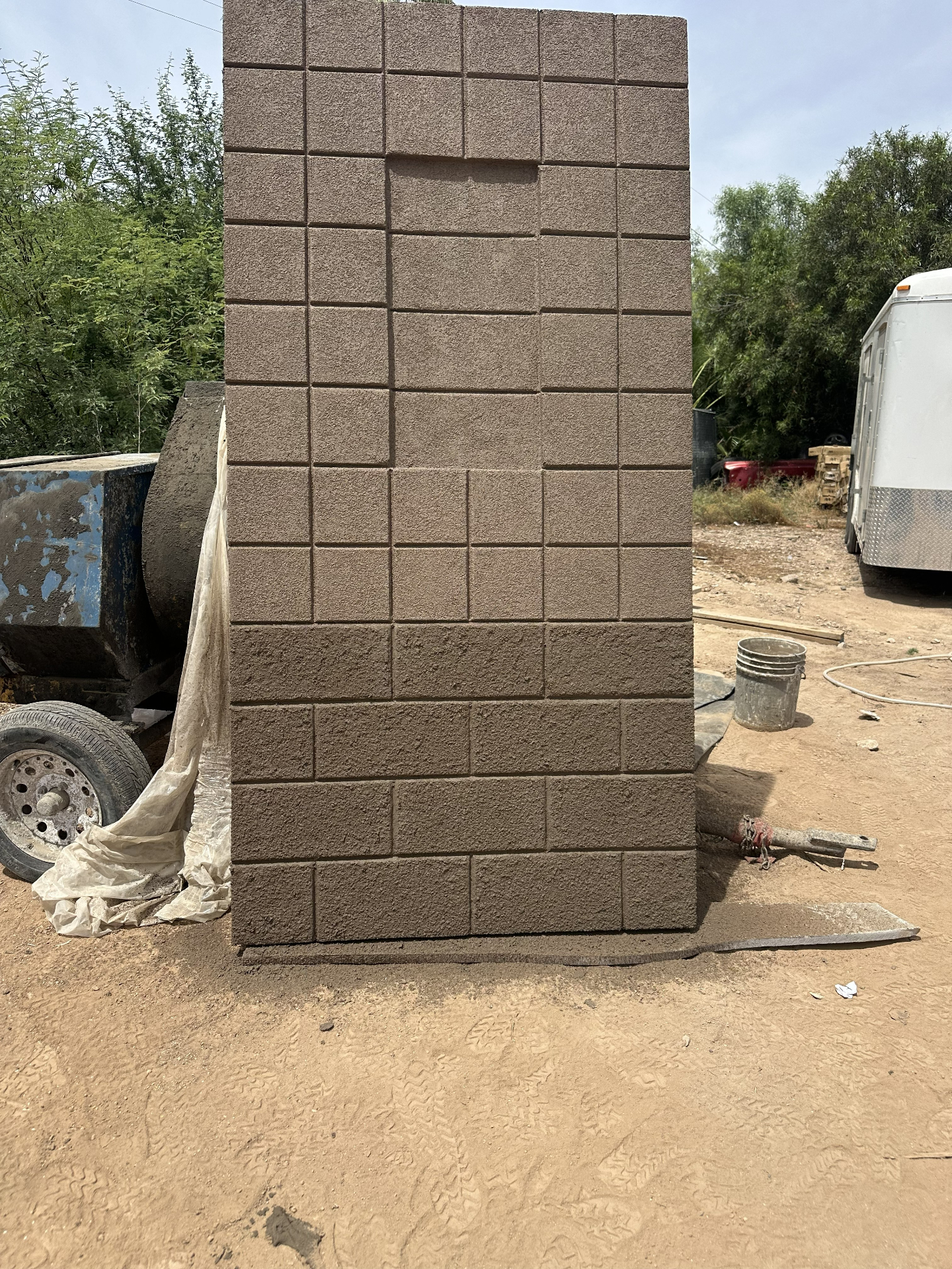 NWB finish sample panel with a sand-colored masonry block texture, shown in the fabrication yard
